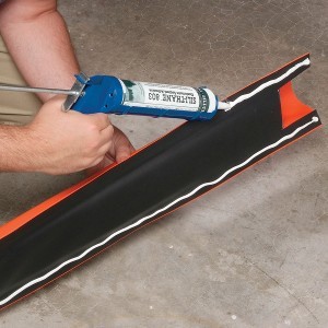 apply floor sealant caulking to spill barrier