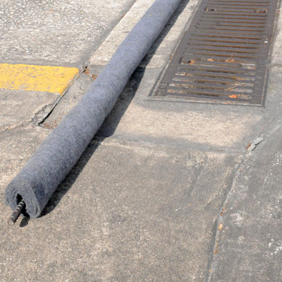 Trench drain filter boom for oil contaminants 