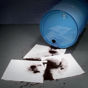 absorbent pads on an oil drum spill