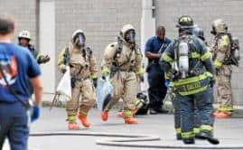 emergency responders in full PPE suits