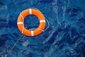 orange life buoy floating at sea