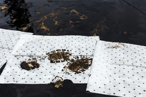 absorbent pad soaking up an oil spill