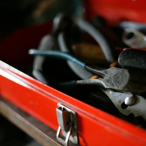red metal toolbox with tools