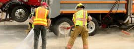 firefighters cleaning up a truck fuel spill