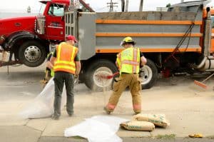 firefighters cleaning up a truck fuel spill