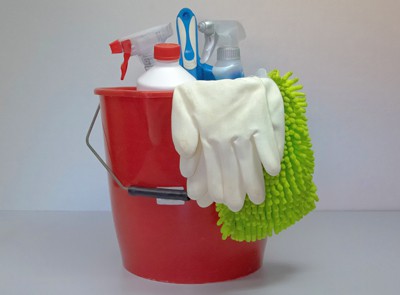 Red bucket containing cleaning supplies