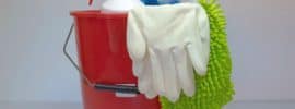 Red bucket containing cleaning supplies