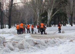 workers shoveling snow