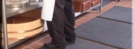 Man standing on anti fatigue mat in kitchen